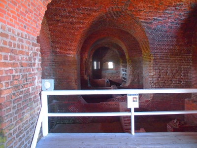 [A series of thick, brick arches as seen from the underside.]